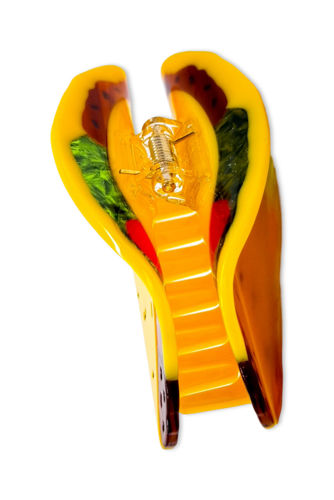 Yellow taco shell hair clip on a white background
