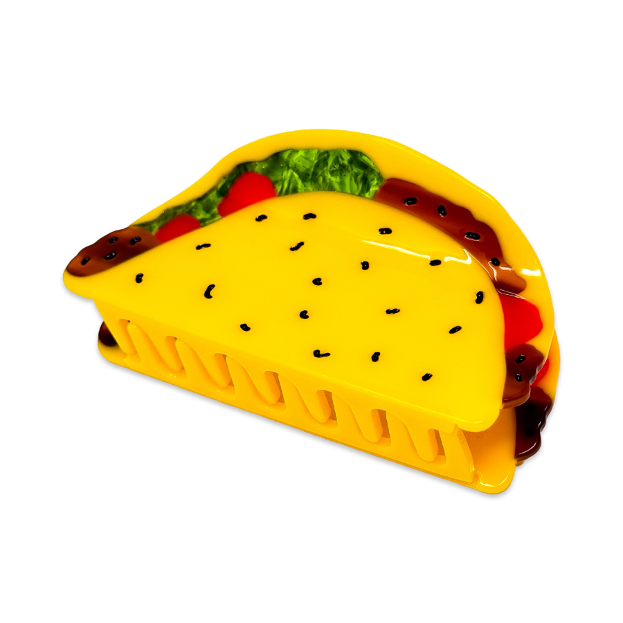 Yellow plastic taco shell hair clip on a white background