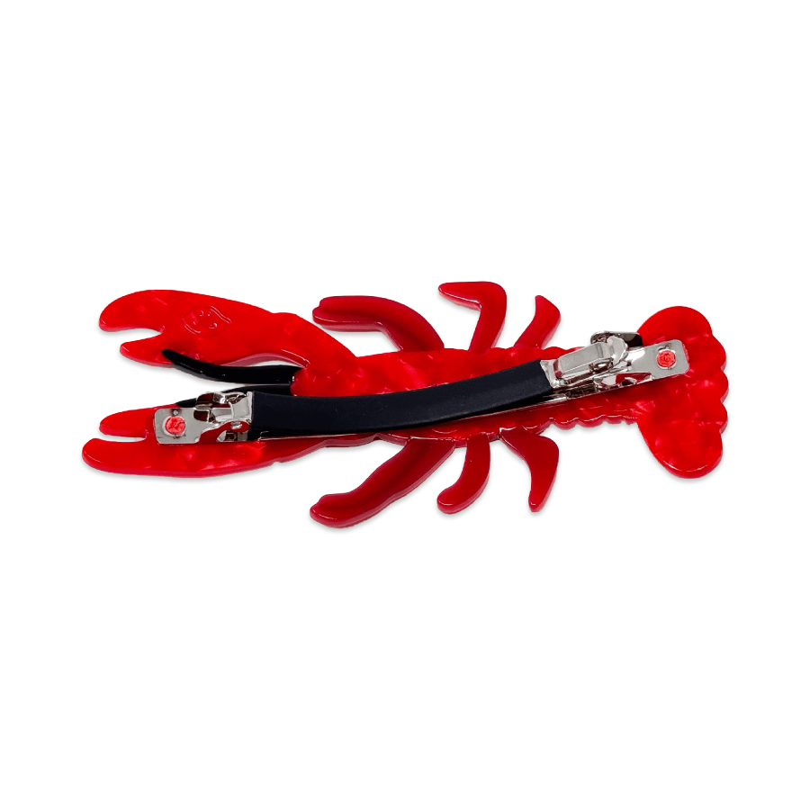 Red lobster-shaped hair clip with black band on a white background