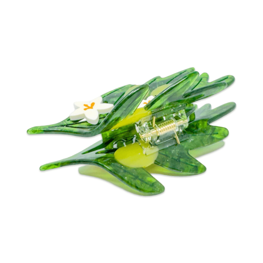 Decorative green leaf with a small white flower and yellow center on a white background