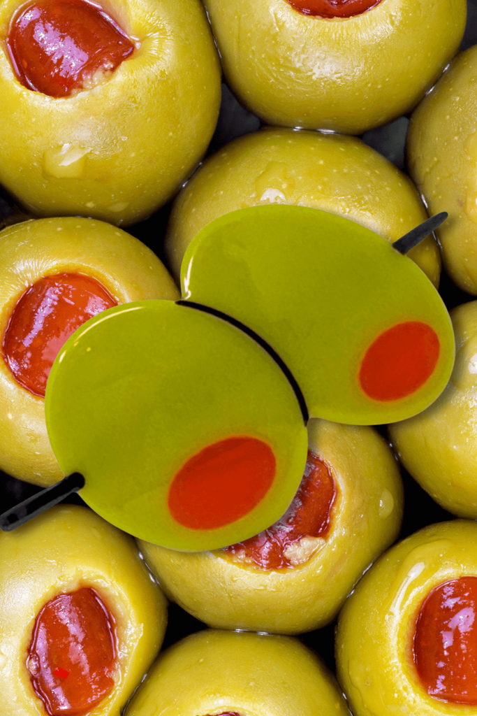 Green olives stuffed with red pepper and a olive shaped hair barrette on top