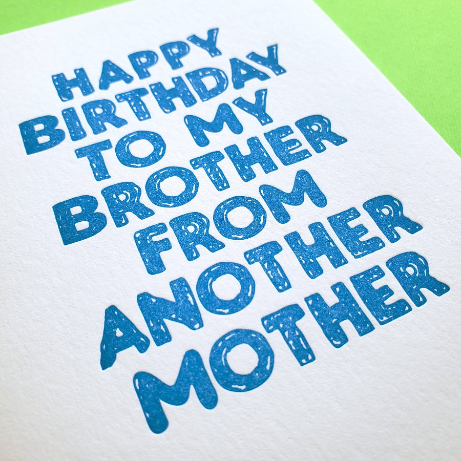 Blue text on a white birthdaycard with a green envelope
