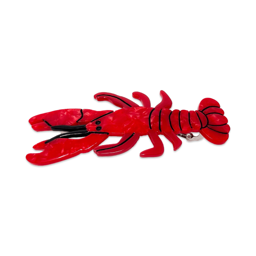 Red lobster-shaped hair barrette on a white background
