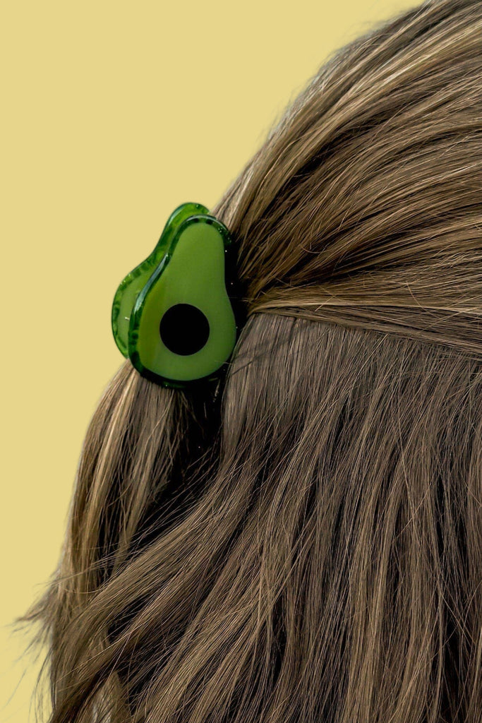 Avocado-shaped hair clip on a person's hair style