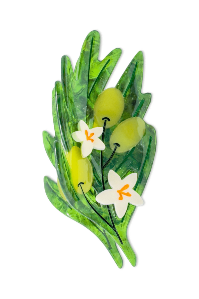 Decorative green olive branch and flower hair clip on a white background