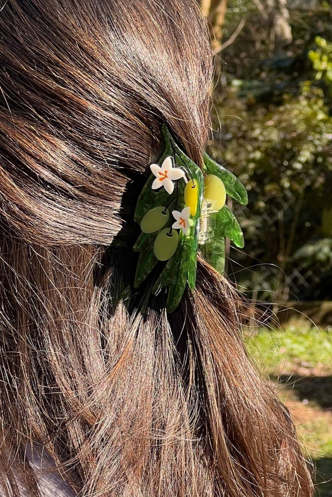 Person with floral  olives hair clip outdoors