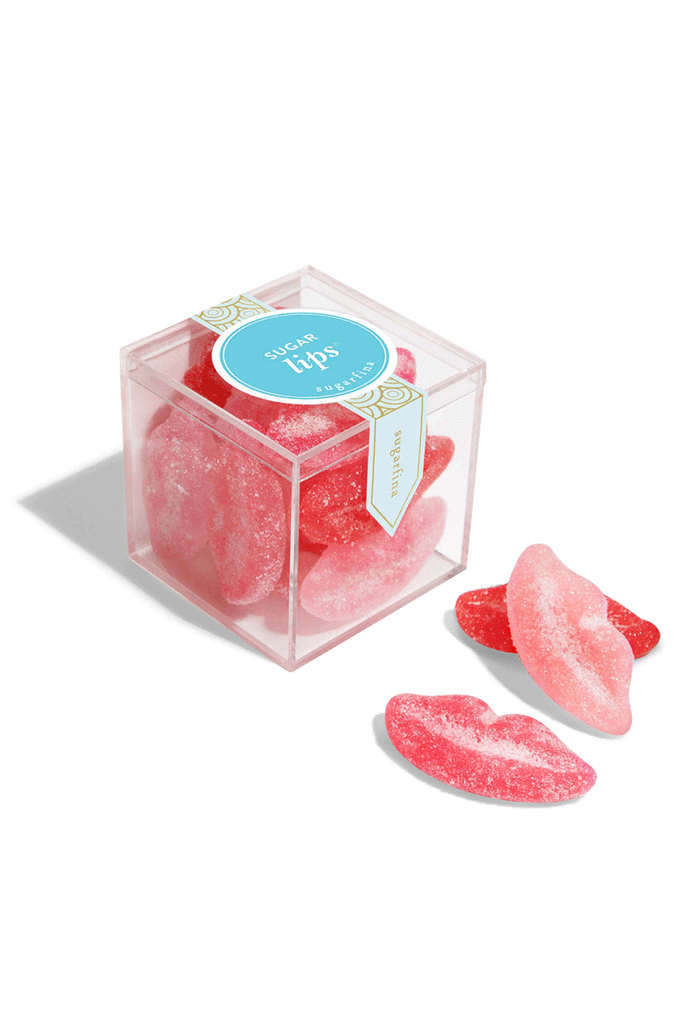 Pink candy lips in a clear box with a blue label on a white background