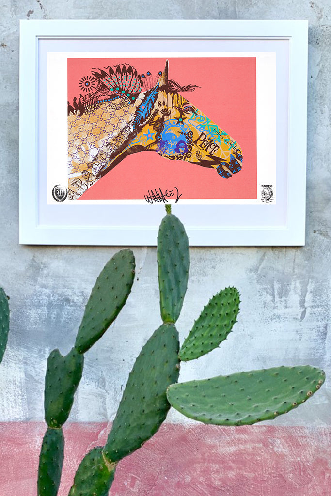 wallace poster electric peace framed on wall with cactus